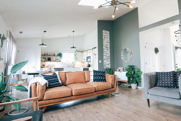 A modern living room with a tan leather sofa